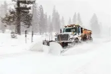  ?? Brian Walker/Special to the Chronicle ?? A Caltrans snowplow clears the road at Echo Summit in Meyers (El Dorado County). The state’s snowpack is at 49% of average.