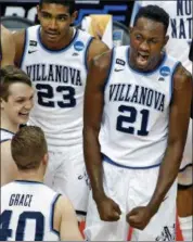  ?? GENE J. PUSKAR - THE ASSOCIATED PRESS ?? Villanova’s Dhamir Cosby-Roundtree (21) celebrates with Denny Grace (40) after an NCAA men’s college basketball tournament second-round game against Alabama in Pittsburgh, Saturday, March 17, 2018. Villanova won 81-58.