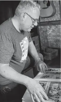  ?? LOGAN MACLEAN • THE GUARDIAN ?? Jeffrey Haight, a former student of Byron Carr, looks over a scrapbook containing instances of gay representa­tion he found in P.E.I. newspapers, including Carr's 1988 murder.