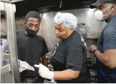  ?? BRIAN RICH/SUN-TIMES ?? Constance Simms-Kincaid (center), co-owner of 5 Loaves Eatery, isn’t applying for a sidewalk cafe permit. Still concerned about the coronaviru­s, she says they’ll stick to takeout.