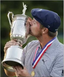  ??  ?? JOHN MINCHILLO — THE ASSOCIATED PRESS Bryson Dechambeau, of the United States, kisses the winner’s trophy after winning the U.S. Open Golf Championsh­ip on Sunday in Mamaroneck, N.Y.