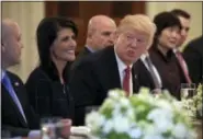  ?? SUSAN WALSH — THE ASSOCIATED PRESS ?? President Donald Trump, sitting next to U.S. Ambassador to the UN Nikki Haley, speaks during a working lunch with ambassador­s of countries on the United Nations Security Council and their spouses, Monday in the State Dining Room of the White House in...