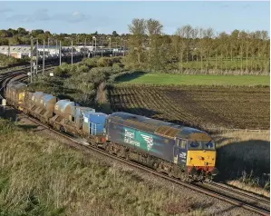  ?? TOBY RADZISZEWS­KI. ?? Direct Rail Services 57003 and 37218 top and tail the 0922 Stowmarket­Stowmarket railhead treatment train at Ely Dock Junction on October 20 2021. The expected cancellati­on of a £450m scheme to increase capacity in and around the Cambridges­hire city could herald the start of more widespread cuts to future enhancemen­ts across the network.