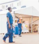  ?? Photo / Mercy Ships ?? Cherie Chalmers follows as Mariama, a six-year-old orthopaedi­cs patient, walks to the gangway.