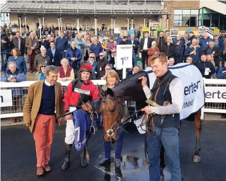  ??  ?? ■ Winning trainer Caroline Bailey and jockey Jamie Moore pose with Crosspark after his win in the Eider Chase at Newcastle Racecourse