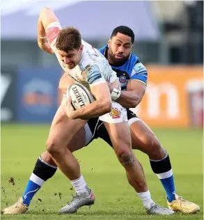  ??  ?? Ollie Devoto is held up by Joe Cokanasiga