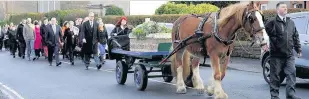  ??  ?? Paying respects Friends and family follow the horse and cart carrying the coffin