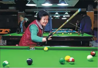  ?? ZOU HONG / CHINA DAILY ?? Fan Xiaomei, 70, a retired official of the Ministry of Education, plays pool at the Yanda Golden Age Health Nursing Center in Yanjiao, Hebe province, which is just outside Beijing.