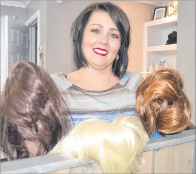  ?? SALLY COLE/THE GUARDIAN ?? Carla Wilson MacKinnon shows a few of the wigs she’s collected that will go to women fighting cancer. The Charlottet­own stylist started the wig exchange as a tribute to her late mother.