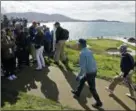  ?? ERIC RISBERG — THE ASSOCIATED PRESS ?? Bill Murray, center, walks up to the gallery to hand out strawberri­es on the seventh hole of the Pebble Beach Golf Links during the third round of the AT&amp;T Pebble Beach Pro-Am Saturday in Pebble Beach, Calif.