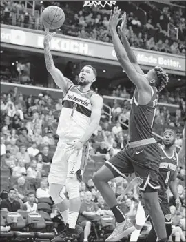  ?? Nick Wass Associated Press ?? WASHINGTON WIZARDS guard Austin Rivers goes to the basket against New York Knicks guard Frank Ntilikina. Rivers faces his father and the Clippers today.