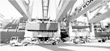  ??  ?? Terminal tractors line up as they are loaded with containers from a cargo ship at DP World’s fully automated Terminal 2 at Jebel Ali Port in Dubai, United Arab Emirates. — Reuters photo