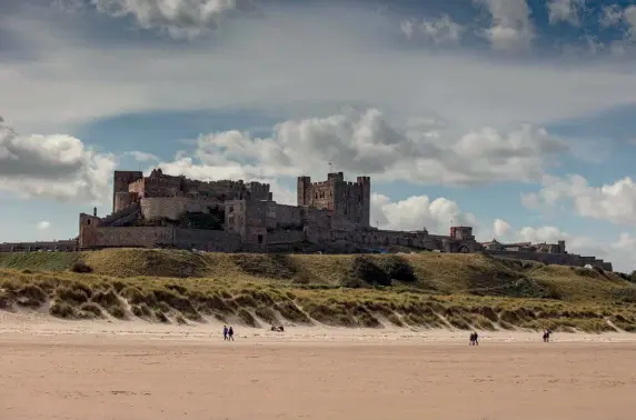  ??  ?? ABOVE Mighty Bamburgh Castle is an impressive sight on the Northumber­land coast BELOW Dip into Bamburgh’s past with a World War II-themed walk where you will learn about this period of its history