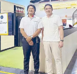  ?? ?? Angkas CEO George Royeca (right) with student-biker JV Ambrosio at the Angkas headquarte­rs.