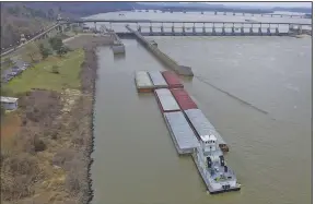  ?? (Arkansas Democrat-Gazette/Staton Breidentha­l) ?? A barge makes its way up the Arkansas River into the lock at Murray Lock and Dam in Little Rock on March 2.