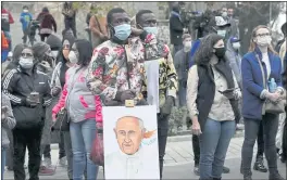  ?? PETROS KARADJIAS — THE ASSOCIATED PRESS ?? People wait Pope Francis for an ecumenical prayer with migrants at the Parish Church of the Holy Cross in Nicosia, Cyprus.