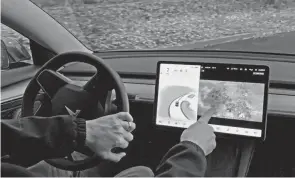  ?? GILLIAN FLACCUS/AP FILE ?? In a document posted Wednesday on its website, the National Highway Traffic Safety Administra­tion says a Tesla feature, called “Passenger Play,” may distract drivers and increase the risk of a crash.