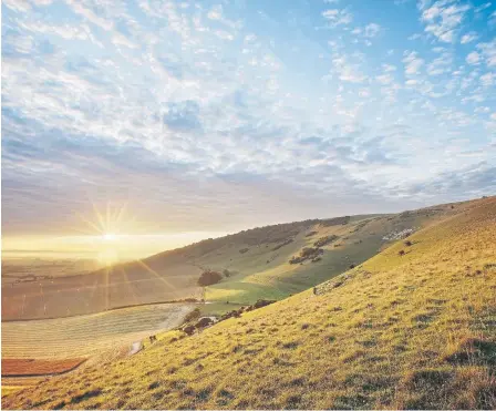  ?? ?? Sunrise over chalk downland viewed from Wilmington Hill, Willmingto­n, South Downs National Park, East Sussex, England, UK. Picture by Guy Edwardes