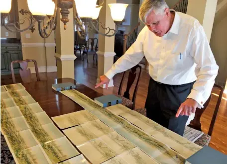  ?? ASSOCIATED PRESS PHOTOS ?? John Kindt looks over early drawings in White, Ga., created in the 1880s by his great-grandfathe­r, Louis Kindt. The drawings were intended to be developed into giant “cycloramas” depicting Civil War battles. Paintings by Louis Kindt will be part of an...