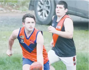  ??  ?? Buln Buln’s Brad Fusinato fires off a handpass to a teammate; Photograph­s: Michael Robinson.