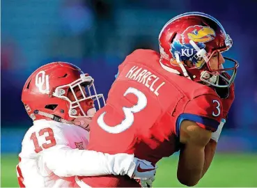  ?? [AP PHOTO] ?? Freshman Tre Norwood, left, nearly had an intercepti­on in OU’s 41-3 win over Kansas. Norwood finished the game with five total tackles and two pass breakups.