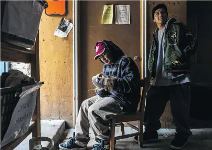  ?? DAVE SIDAWAY ?? Inuit carvers Tommy Kingwatsia­k, left, and Nemo John Awa at The Open Door. Kingwatsia­k says carving earns him money for an afternoon movie or a trip to the arcade. He wants to save up for a plane ticket home to Cape Dorset, where his grandfathe­r once...