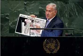  ?? AP Photo/RIchARd dRew ?? Israel’s Prime Minister Benjamin Netanyahu shows guided missile sites in Beirut during his address of the 73rd session of the United Nations General Assembly, at U.N. headquarte­rs, on Thursday