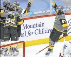  ?? Joe Mahoney The Associated Press ?? Mark Stone, right, is late to the party as teammates rejoice with Max Pacioretty, left arm raised, after his overtime winner.