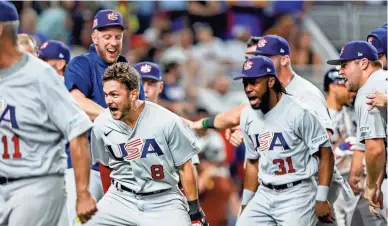  ?? SAM NAVARRO/USA TODAY SPORTS ?? USA shortstop Trea Turner (8) celebrates with teammates after hitting a grand slam during the eighth inning against Venezuela.