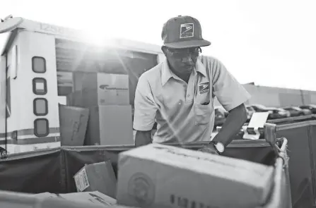  ?? ADAM CAIRNS/COLUMBUS DISPATCH ?? Mail carrier Edward Medley, 55, of Groveport, said the volume of mail has increased so much during the COVID-19 pandemic that sometimes he and his colleagues have to work as long as 12 hours a day or split up their routes in order to get their work done each day.