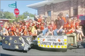  ?? Westside Eagle Observer/SUSAN HOLLAND ?? Members of the second-and-third grade football team at Glenn Duffy Elementary School wave to friends and family as they take the debut ride on their “Hollywood Premiere” float in the homecoming parade Friday, Sept. 27. Great football players at Gravette High School often start young and come up through the ranks.