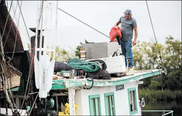  ?? LESLIE WESTBROOK/THE ADVOCATE ?? Timothy Schouest adds diesel to his boat in preparatio­n for Hurricane Delta on Thursday in Delcambre, Louisiana. The Category 3 storm is expected to make landfall Friday evening.