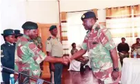  ?? ?? Lieutenant General Anselem Nhamo Sanyatwe congratula­tes Brigadier-General Arnold Gumbo yesterday after receiving his new rank