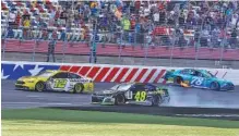  ?? AP PHOTO/CHUCK BURTON ?? Ryan Blaney (12) drives past the wrecked cars of Jimmie Johnson (48) and Martin Truex Jr. (78) to win Sunday’s race on the “roval” layout at Charlotte Motor Speedway in Concord, N.C. Johnson collided with Truex after trying to slip past for the victory.