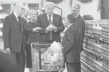  ?? Saul Loeb / AFP / Getty Images ?? President Donald Trump tours the Church of Jesus Christ of Latter-Day Saints’ food distributi­on center Monday at LDS Welfare Square in Salt Lake City. Church officials told Trump how the center provides food to the poor and victims of natural...