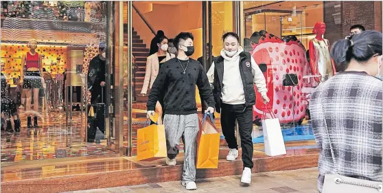  ?? Picture: REUTERS/LAM YIK ?? Shoppers walk out of a luxury store at Tsim Sha Tsui district in Hong Kong, China.