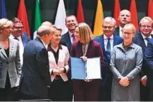  ?? AFP ?? EU Foreign Policy Chief Federica Mogherini (centre) poses with foreign and defence ministers from 23 EU member states after they signed the deal yesterday.