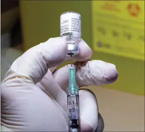  ?? The Canadian Press ?? A Pfizer-BioNTech COVID-19 vaccine dose is prepared at The Michener Institute in Toronto.