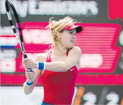  ?? MARK BLINCH/THE CANADIAN PRESS ?? Eugenie Bouchard of Montreal returns a shot to Donna Vekic of Croatia during their first-round match at the Rogers Cup tennis tournament in Toronto on Tuesday. Bouchard lost in straight sets, 6-3, 6-4, and her ranking is likely to slip from 70th in the world.