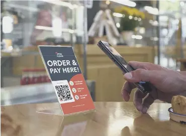  ??  ?? 0 Customers scan a QR code at their table with their phone