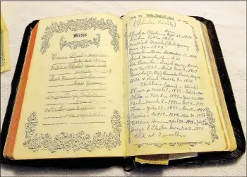  ?? (NWA Democrat-Gazette/Lynn Atkins) ?? This Bible, printed in the 1950s, has little monetary value but lots of family history. The family names on these pages include Plaster, Griffiths and Barnes.