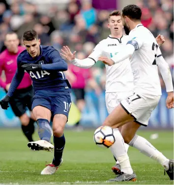  ?? — AP ?? Tottenham Hotspur’s Erik Lamela ( left) scores against Swansea City in their FA Cup quarter- final at the Liberty Stadium in Swansea on Saturday. The Spurs won 3- 0.