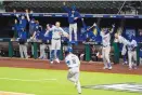  ?? TONY GUTIERREZ/ASSOCIATED PRESS ?? The Dodgers celebrate as Will Smith rounds third after hitting a three-run homer in the sixth inning Friday that gave Los Angeles a 4-2 lead over Atlanta in Game 5 of the NLCS.