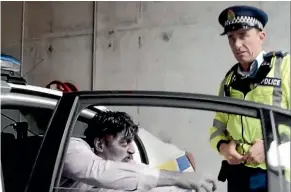  ?? NZ POLICE ?? Wellington Paranormal’s Officer Minogue loses his spirit as a zombie tries to lurch from a patrol car in a scene from police’s latest summer road safety campaign video.