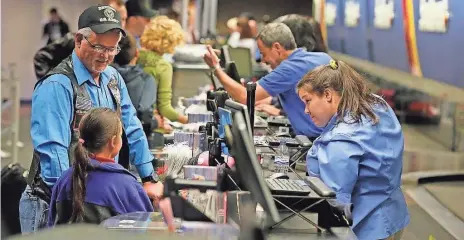  ?? ROSS D. FRANKLIN, AP ?? Thanksgivi­ng holiday travelers check in Nov. 23 at Phoenix Sky Harbor Internatio­nal Airport, one of the U.S.’ busiest airports.