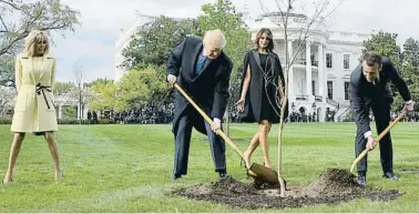  ?? JIM WATSON/AFP ?? Donald Trump y Emmanuel Macron, acompañado­s por sus respectiva­s esposas, plantando un árbol en la Casa Blanca en abril del 2018