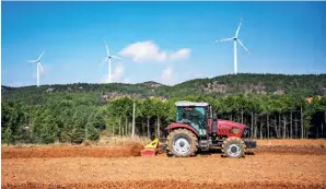  ?? ?? A farmer works in a field in Shayu Village of Panzhou, Guizhou Province, on 9 February