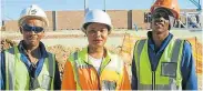  ??  ?? WORK FOR SOME: Workers at the Customs Control Warehouse being built in the Coega Special Economic Zone are, from left, Thandazani Mbanga, 30, Nikelwa Mbumba, 25, and Antonio Fisher, 23