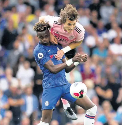  ?? AP ?? Chelsea’s Tammy Abraham (left) and Leicester City’s Caglar Soyuncu battle for the ball during the English Premier League match between their teams at the Stamford Bridge stadium in London yesterday. The match ended in a 1-1 draw.