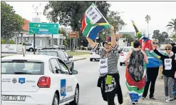  ??  ?? ANTI-ZUMA PROTEST: Demonstrat­ors hold placards that call for President Jacob Zuma to be removed from office